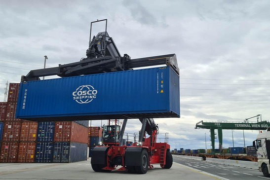 Stacker lifts container