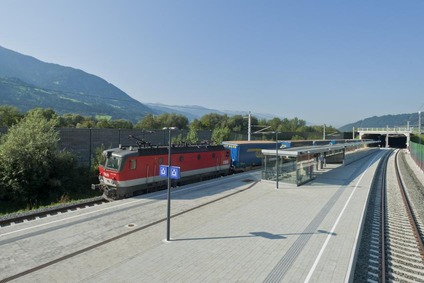 © ÖBB/Gerhard Berger View of a train passing a train station on the Brenner axis