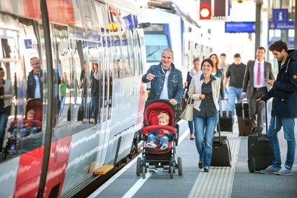 View of customers taking a train at a train station.