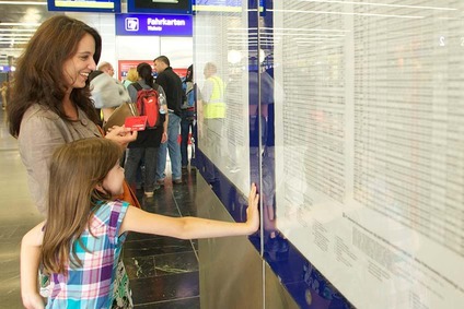 Customer in front of a timetable display case