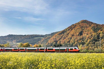 Train runs through landscape