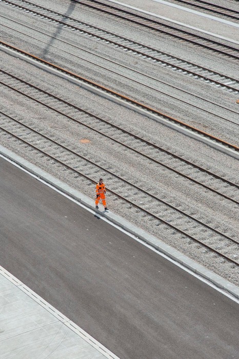 An employee walks along the tracks.<br/>