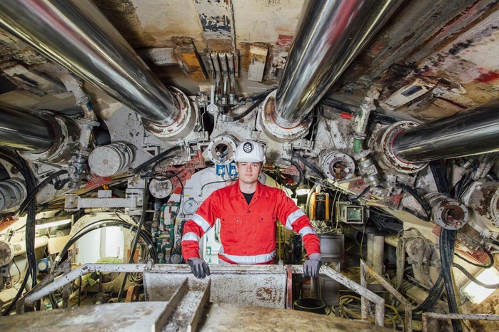 A mechanic takes care of the functionality of a tunnel drilling machine.