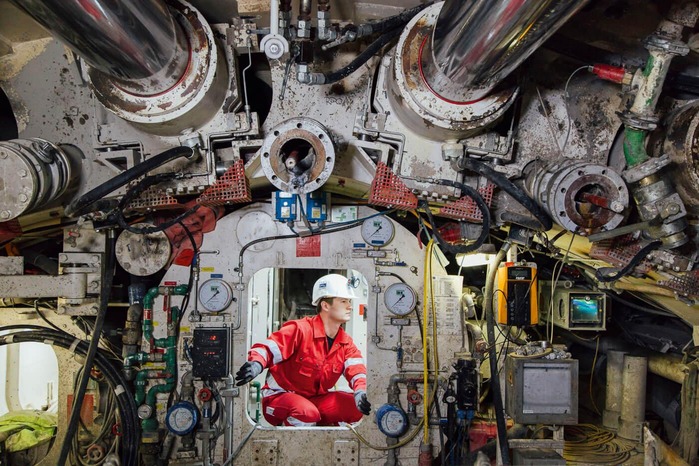 A mechanic checks the different values of a tunnel drilling machine.