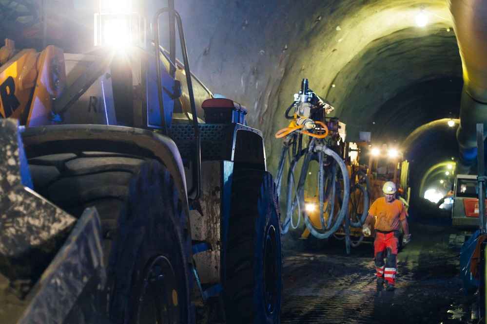 A miner makes his way to a wheel loader.