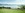 Zug in Landschaft, See dahinter
