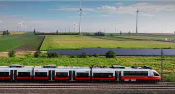Cityjet vor PV und Windrädern