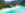 Urlaub am Weissensee: Panoramaaufnahme von einem Weissensee-Strand mit türkisblauen Wasser. 
