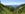 Aussicht auf Wald, Wiesen und Berggipfel