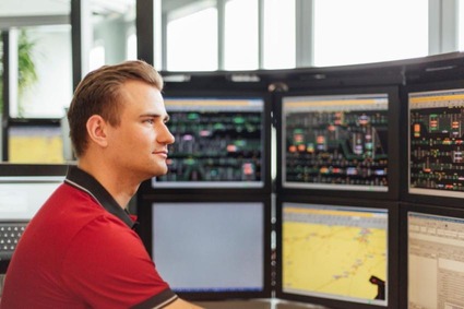 Train dispatcher in front of screens