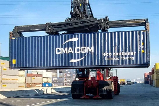 Crane vehicle loading a container