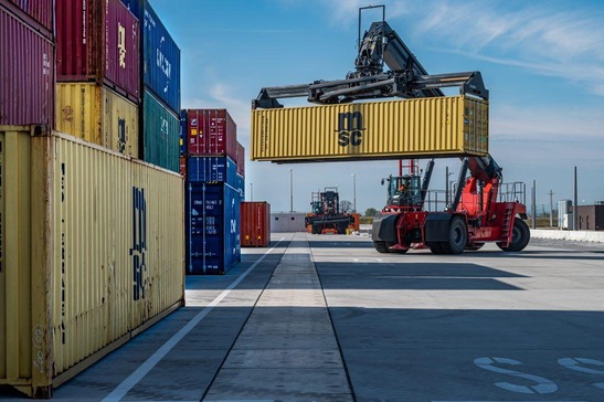 Crane stacks containers on top of each other