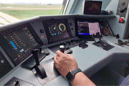 infraDOAS tablet in operation in a driver's cab, and the driver's hand on the control lever