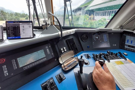 View from the driver's cab through the window, infradoas tablet on the left-hand side, hand on the control stick