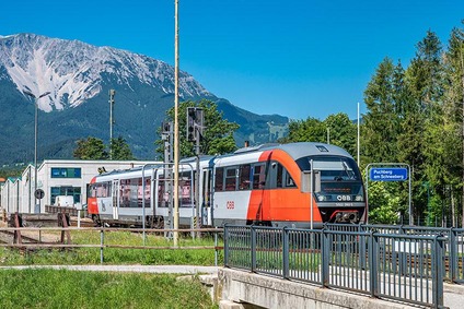 Foto Bahnhof Puchberg am Schneeberg<br/>Textinsert: Haltestelle mit Zug und Bergen im Hintergrund