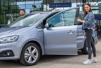 Zwei Personen vor einem Rail&Drive Auto