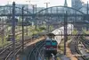 Rail tracks with train leaving a city