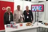 Messestand der ÖBB INFRA auf der Fachmesse Movatec in Dornbirn mit drei Standbetreuenden.