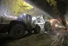 Several excavators working in a tunnel tube.