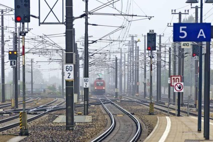 Rail track with catenary and train in the distance