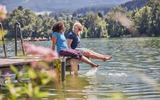 2 Personen sitzen auf dem Steg 