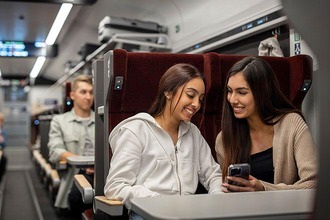 Mädchen im Sitzwagen comfort schauen auf Smartphone