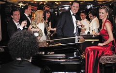 Gäste und Klavierspieler im Barwagen