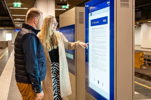 People in front of a digital information column