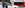Personen stehen vor Rail&Drive Auto