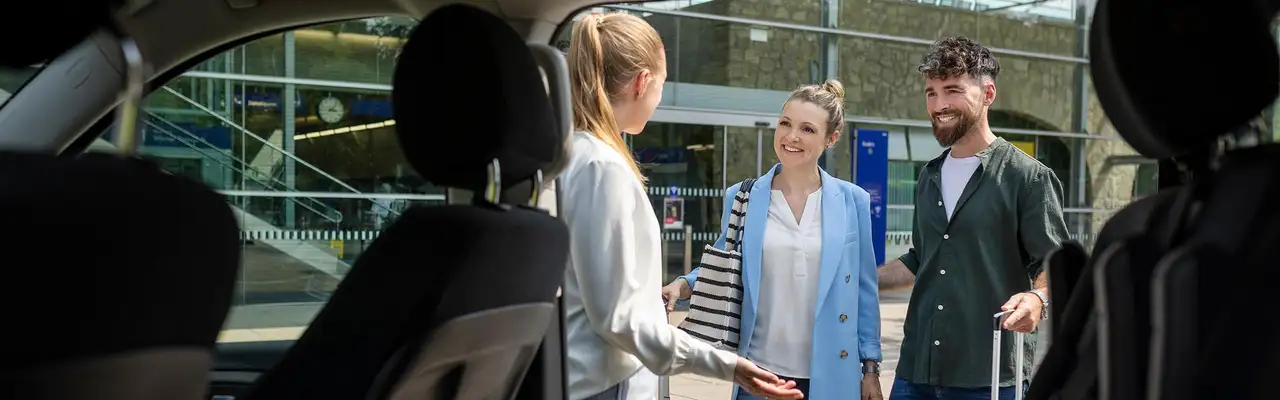 Perosnen steigen in Auto ein