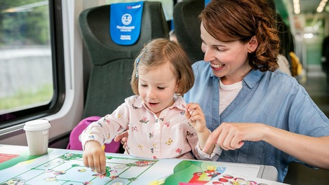 Man reads with son in the ÖBB Railjet