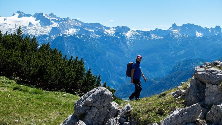 Hiker in front of a beautiful mountain panorama