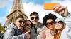 smiling friends taking selfie with smartphone