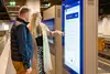 People in front of a digital information column