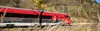 Railjet fährt mit hoher Geschwindigkeit durch hersbtliche Landschaft