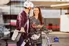 Man and woman in front of e-bikes