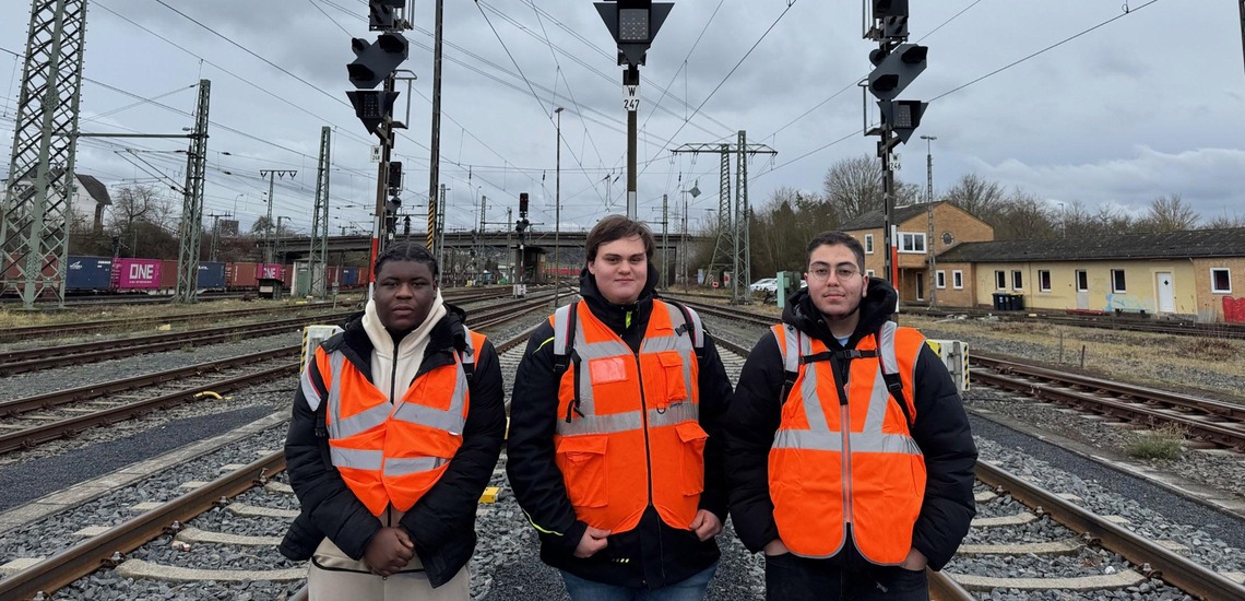 Rail Cargo Group apprentices wearing safety vests in a rail yard