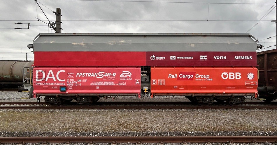 Talns freight wagon marked for DAC testing standing on railway tracks.