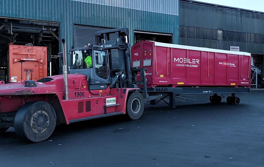 Rail Cargo Group MOBILER unit being handled by forklift at terminal.