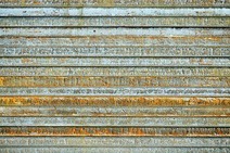 Construction steel – stacked metal beams with traces of rust.