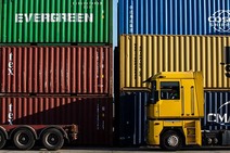 Bilk Terminal Budapest with stacked containers and a yellow truck in front.