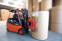 Warehouse Lenzing with a forklift operator moving large paper rolls