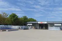 Warehouse Novi Zagreb with exterior view, stacked metal racks, and forklifts in front of the building