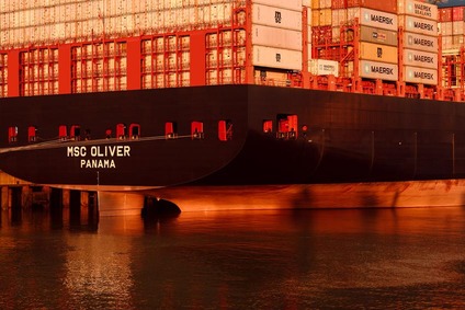 Container ship MSC Oliver at port with stacked containers for sea freight
