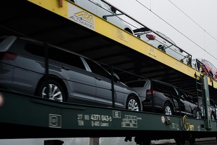 Car carrier wagon transporting multiple passenger cars on two levels