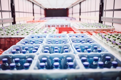 Crates of bottled beverages neatly stacked inside a transport unit for consumer goods
