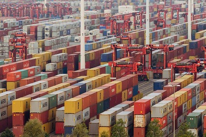 Container terminal with stacked shipping containers and cranes.