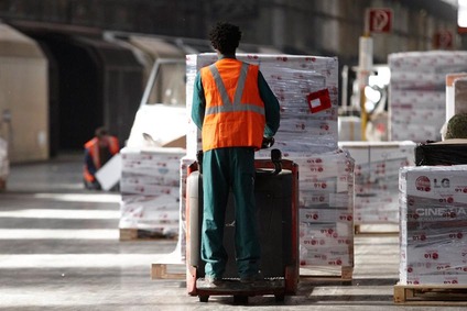 Worker with pallet truck moving pallets in Rail Cargo Group warehouse in Croatia