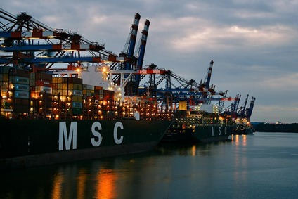 Container ships and cranes at port symbolising sea freight transport
