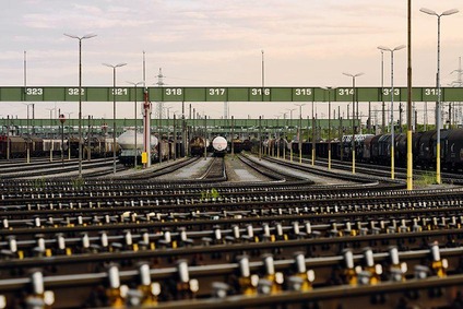 View of a marshalling yard with multiple tracks and parked freight wagons.